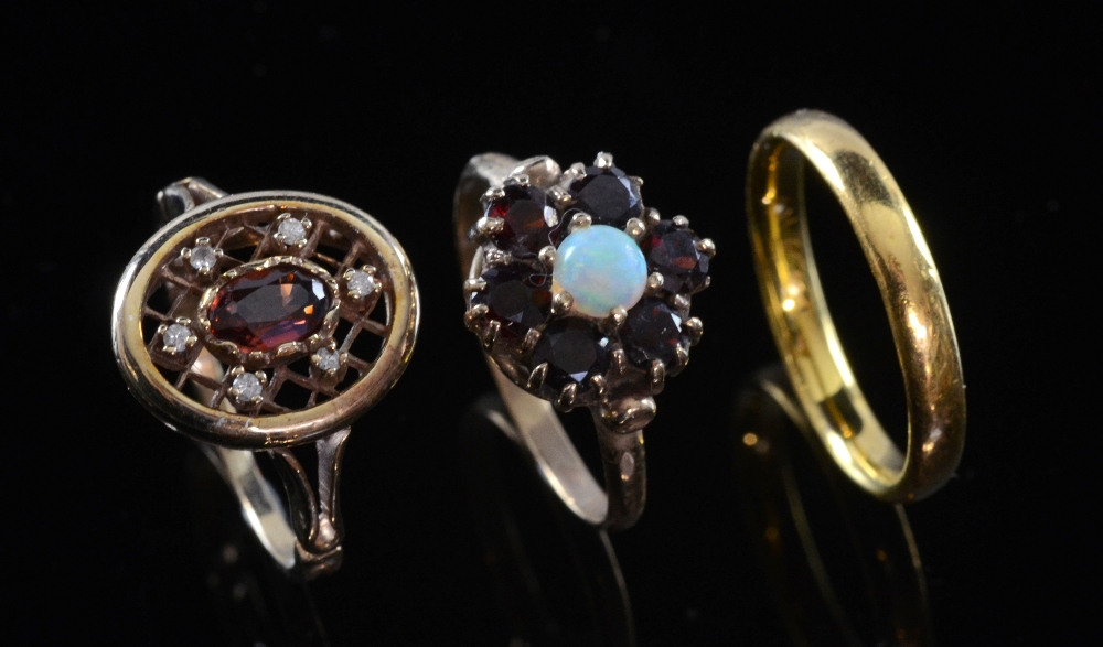 Gold wedding band 22 ct, garnet and opal ring in floral setting and another in open setting both 9ct