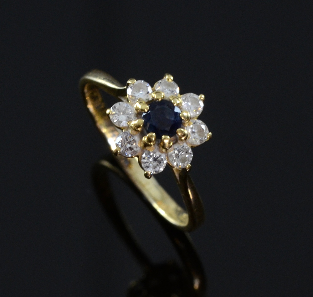 Diamond and sapphire ring in floral setting 18ct stamped 750