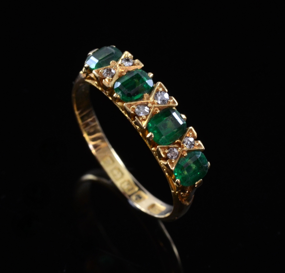 Emerald and diamond ring set in 18 ct goldoveral condition good minor ware conjusive to use