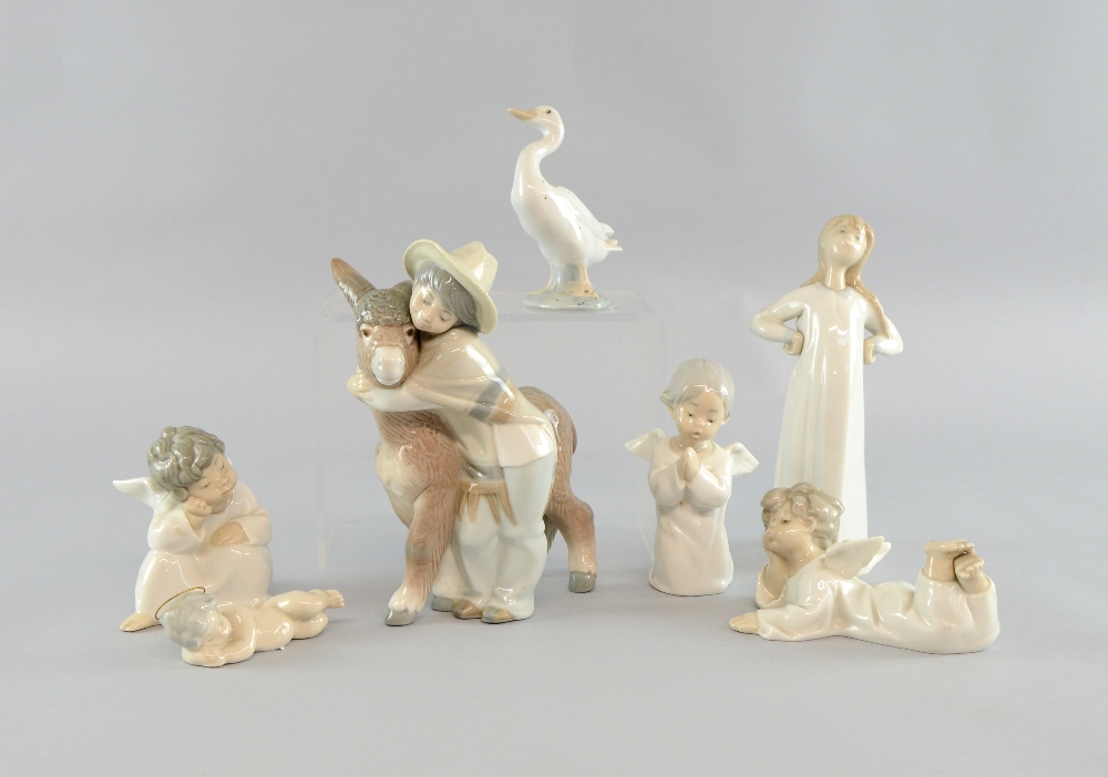 Seven Lladro figures, boy with donkey, four cherubs, and a young girl with goose