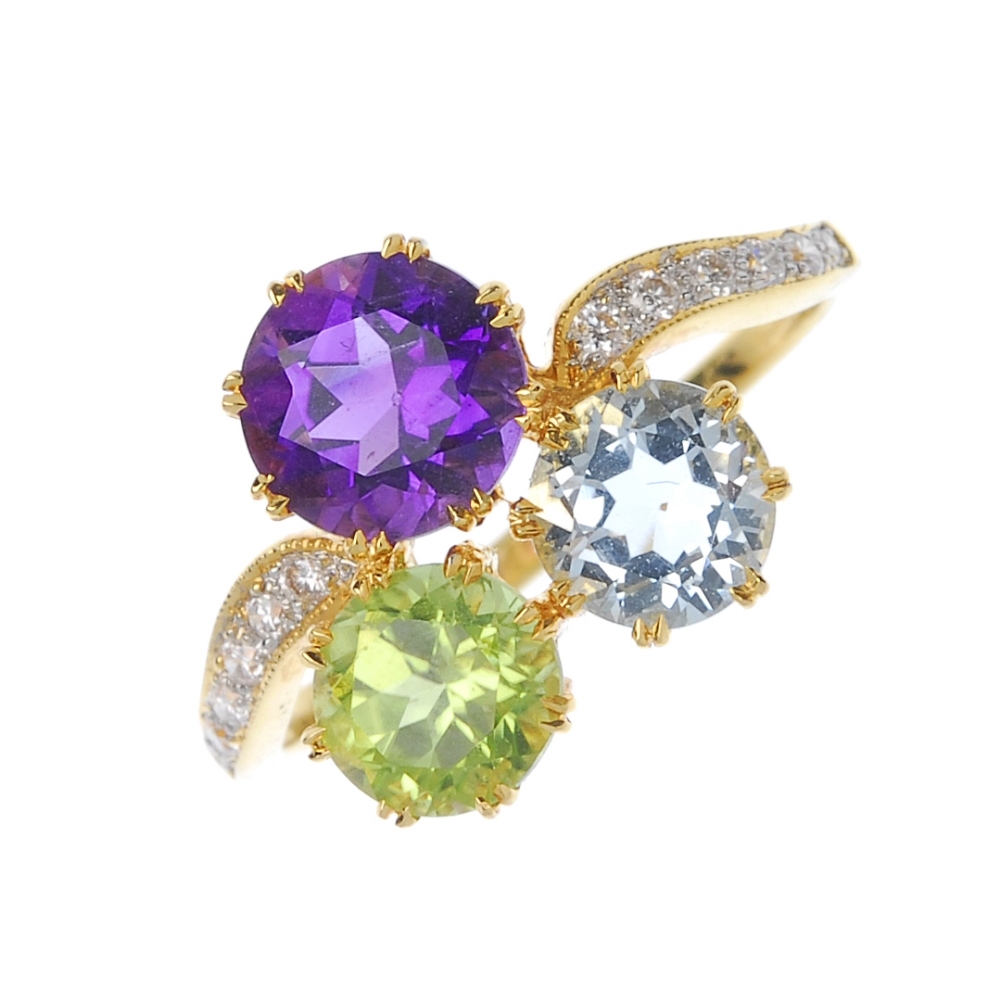 An 18ct gold gem-set dress ring. The circular-shape amethyst, peridot and aquamarine trefoil, to