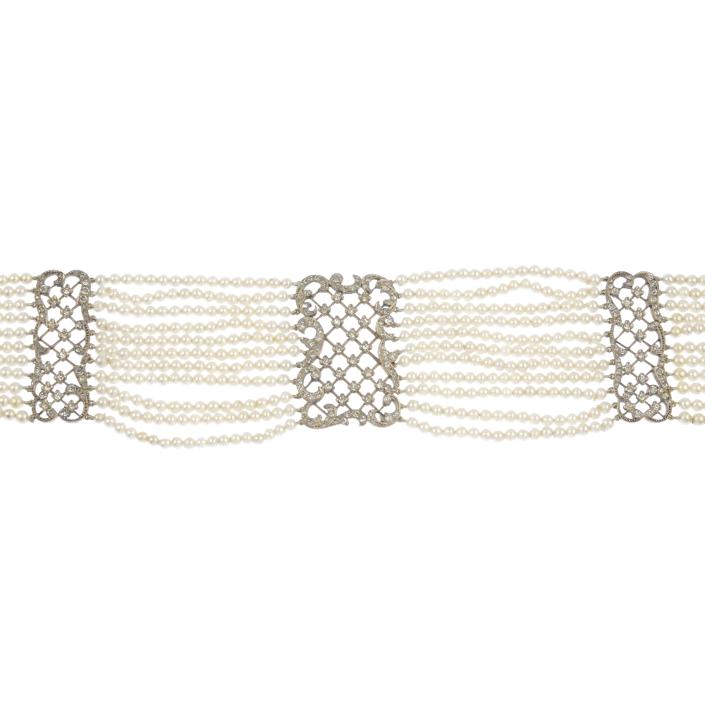 An early 20th century imitation pearl and paste silver gilt choker, designed as ten rows of uniform