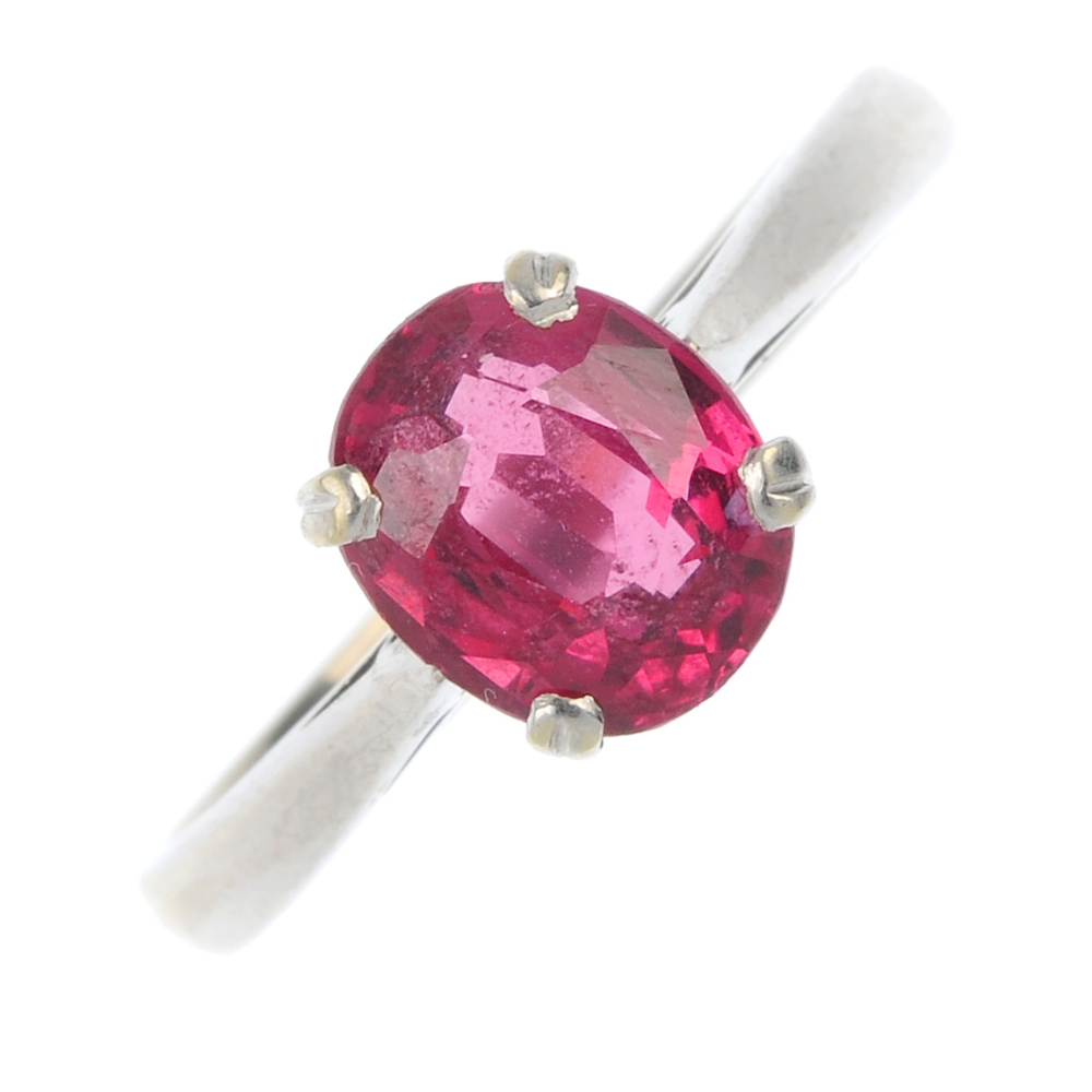 A 9ct gold spinel single-stone ring. The oval-shape red spinel, to the plain band. Dimensions of