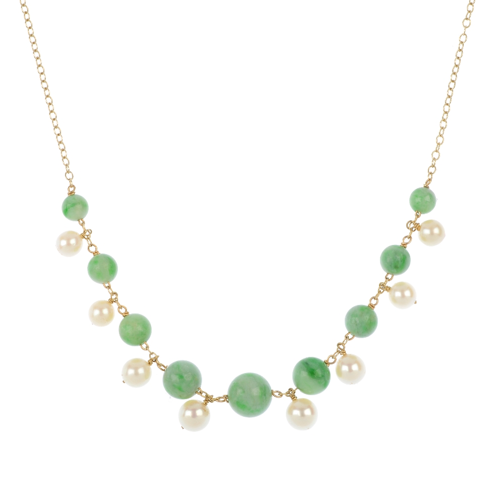 A jade and cultured pearl necklace and a jade ring. The necklace designed as a series of graduated