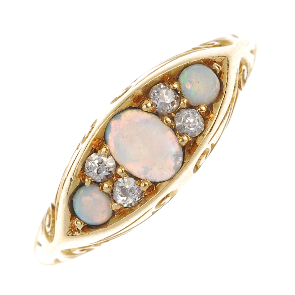 A late 19th century 18ct gold opal and diamond ring. The oval and circular opal cabochon and old-