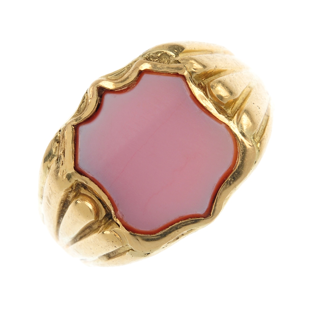A mid 20th century 18ct gold sardonyx signet ring. The shield-shape sardonyx panel, to the grooved