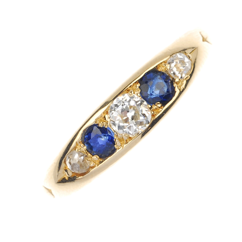 A late Victorian 18ct gold diamond and sapphire ring. The alternating graduated old-cut diamond and