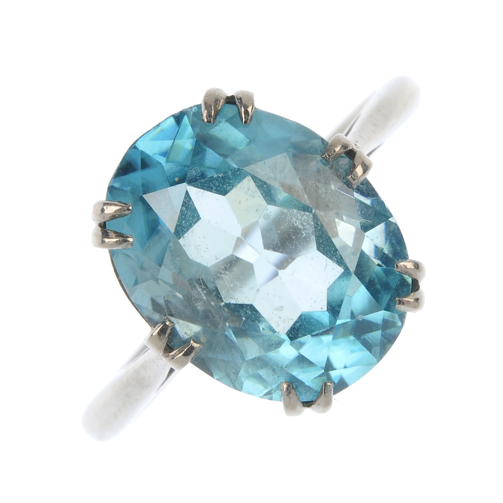 A mid 20th century 18ct gold zircon single-stone ring. The oval-shape blue zircon, to the openwork