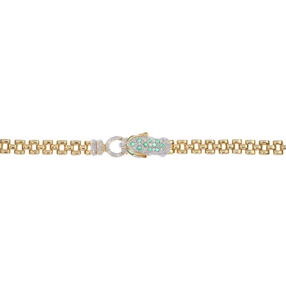 A 9ct gold diamond and emerald leopard bracelet. Designed as a circular and oval-shape emerald and