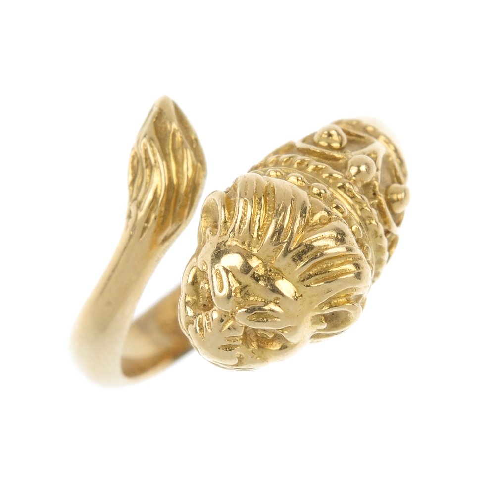 A lion ring. Of asymmetric design, the lion mask and tail terminals, with rope-twist and bead