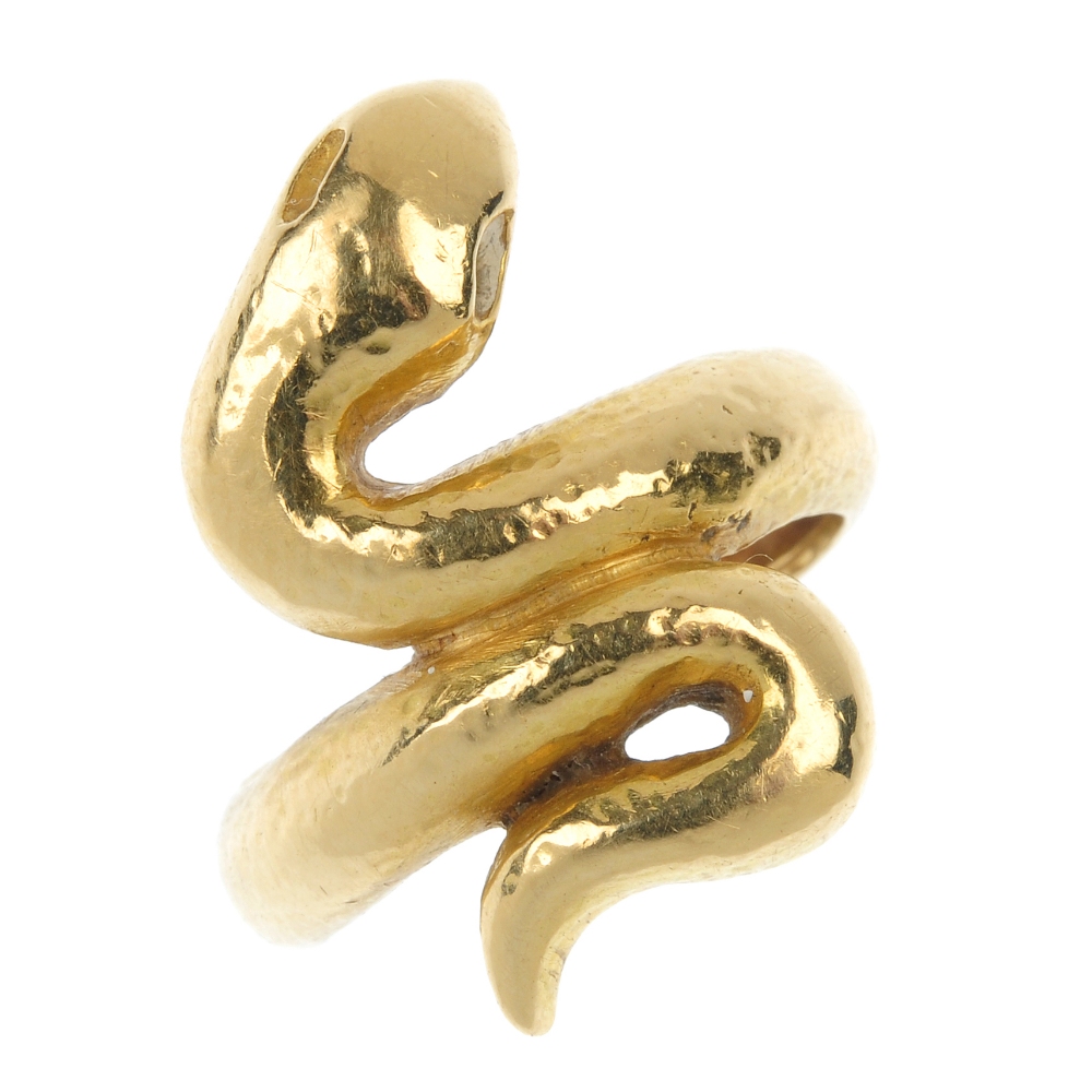 A snake ring. Designed as a coiled snake, with textured finish and indented eyes. Weight 8.1gms.