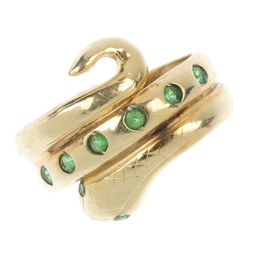 A paste snake ring. Designed as a coiled snake, with circular-shape green paste detail. Ring size H
