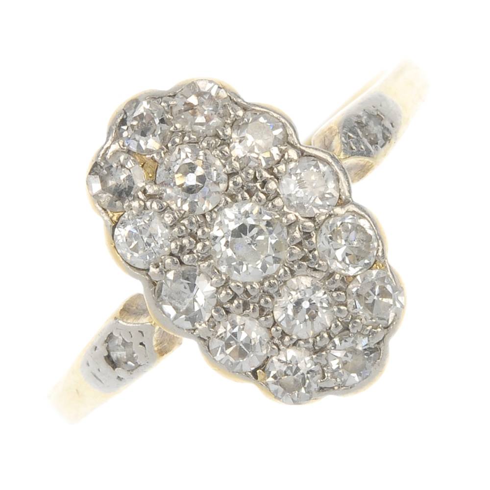 An early 20th century 18ct gold and platinum diamond dress ring. The vari-cut diamond scalloped