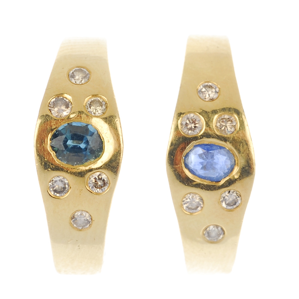 A pair of sapphire and diamond earrings. Each designed as an oval-shape sapphire, with brilliant-