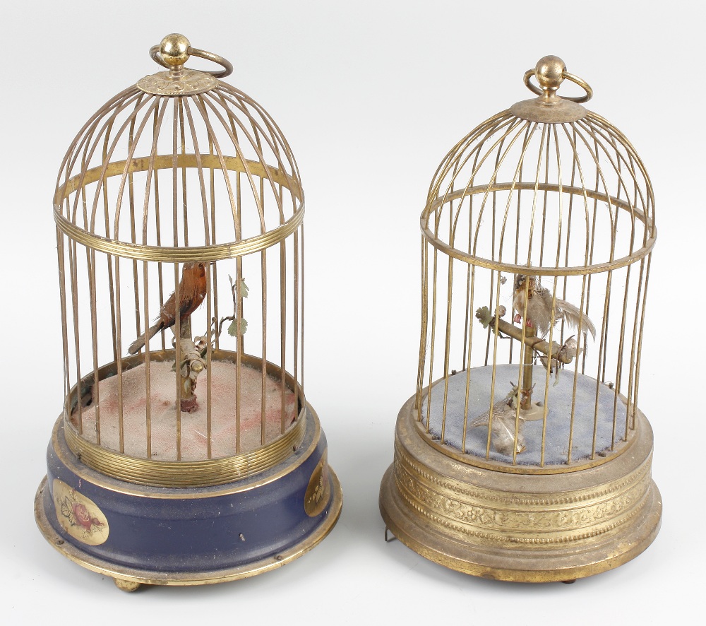 Two 20th century singing bird automata, each with domed bird cage, the first German, with blue