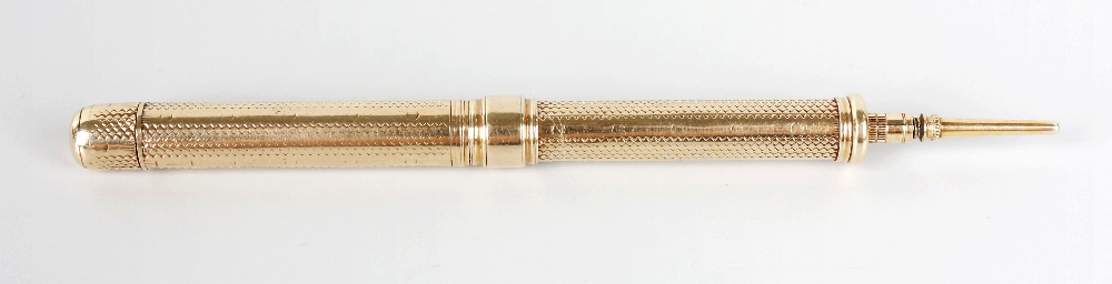 A yellow metal retractable combination pencil and fountain pen, the textured barrel with sliding