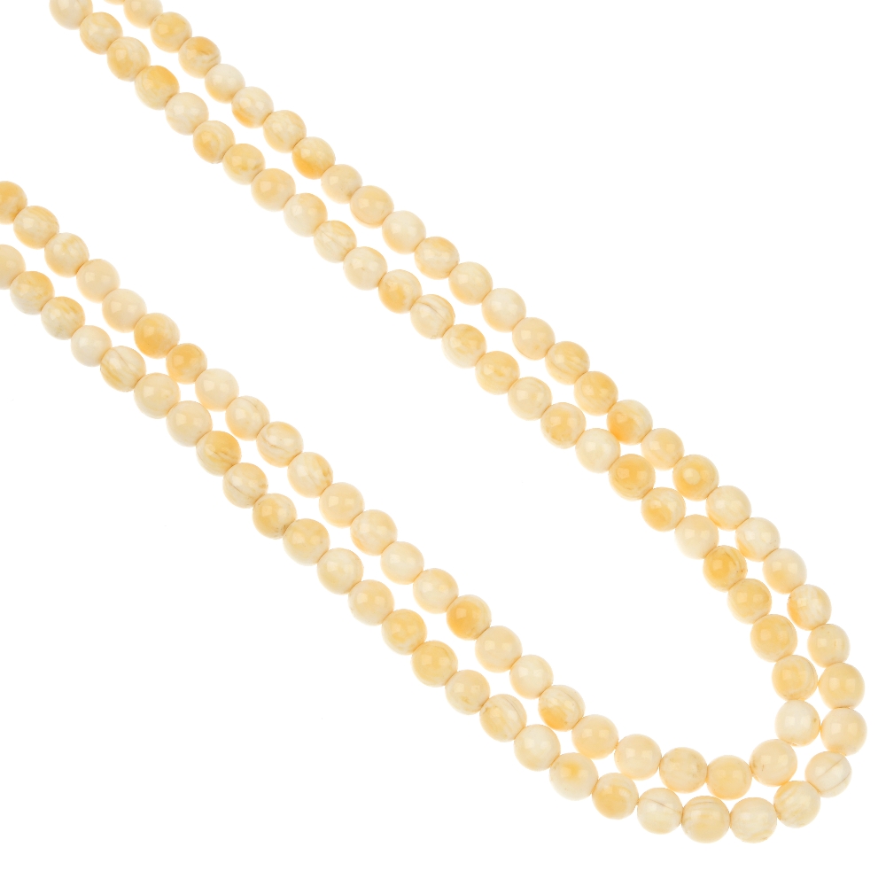 An early 20th century long ivory bead necklace, designed as 166 uniform spherical beads measuring