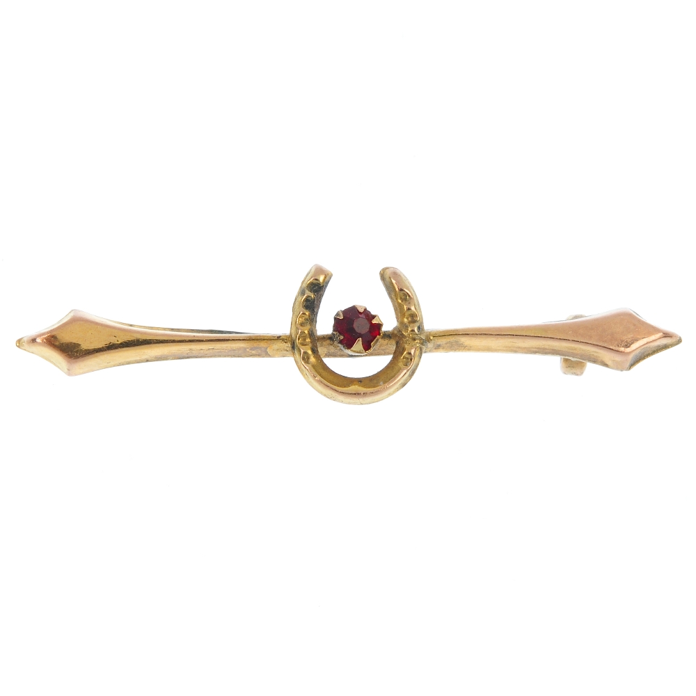 A selection of jewellery, to include an early 20th century 9ct gold red-gem brooch, a Trifari