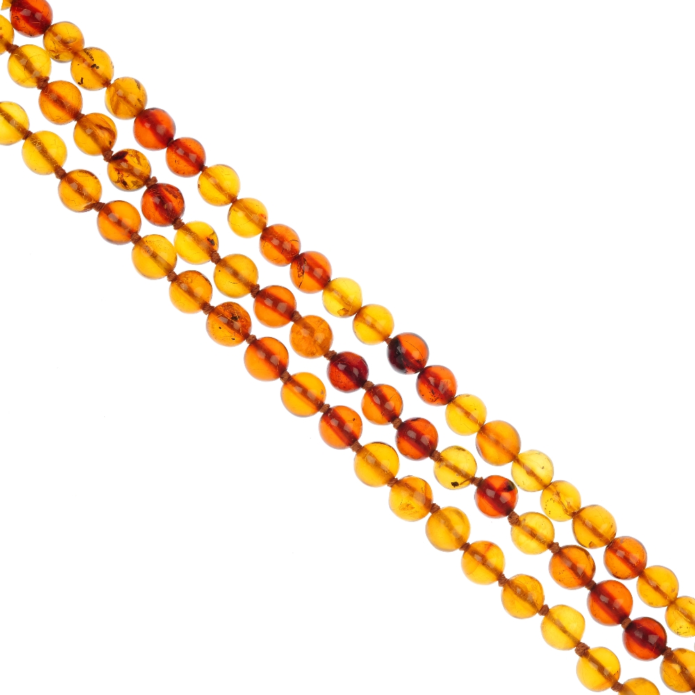A three row amber bead necklace, comprising three strands of spherical amber beads measuring 8.1 to