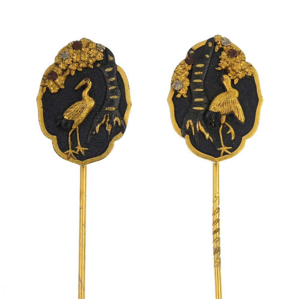 A pair of late 19th century Japanese Shakudo stickpins, each designed as a cartouche-shape panel