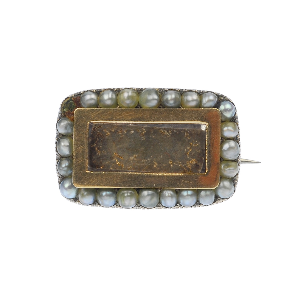 A late Georgian split pearl mourning brooch, the rectangular-shape glazed panel, to the a split