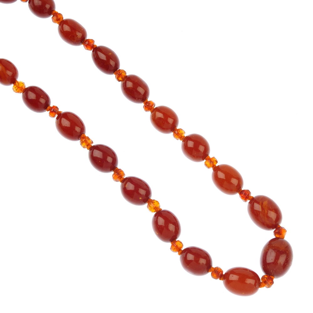 A natural and reconstructed amber bead necklace, the nineteen oval-shape natural amber beads