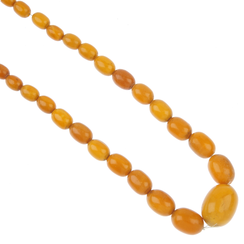 A natural amber bead necklace, designed as forty-five graduated barrel-shape amber beads measuring