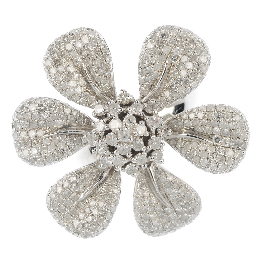 A silver diamond floral ring. The brilliant-cut diamond stepped cluster, with six articulated pave-