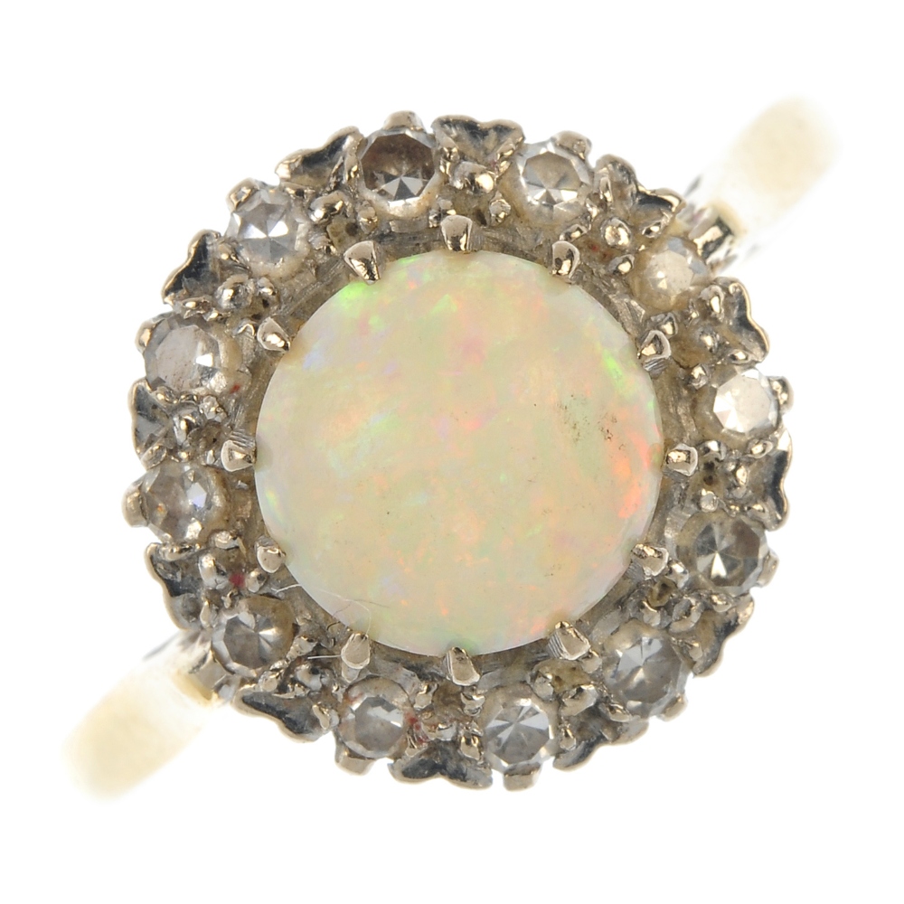 An 18ct gold opal and diamond cluster ring. The circular opal cabochon, within a single-cut diamond