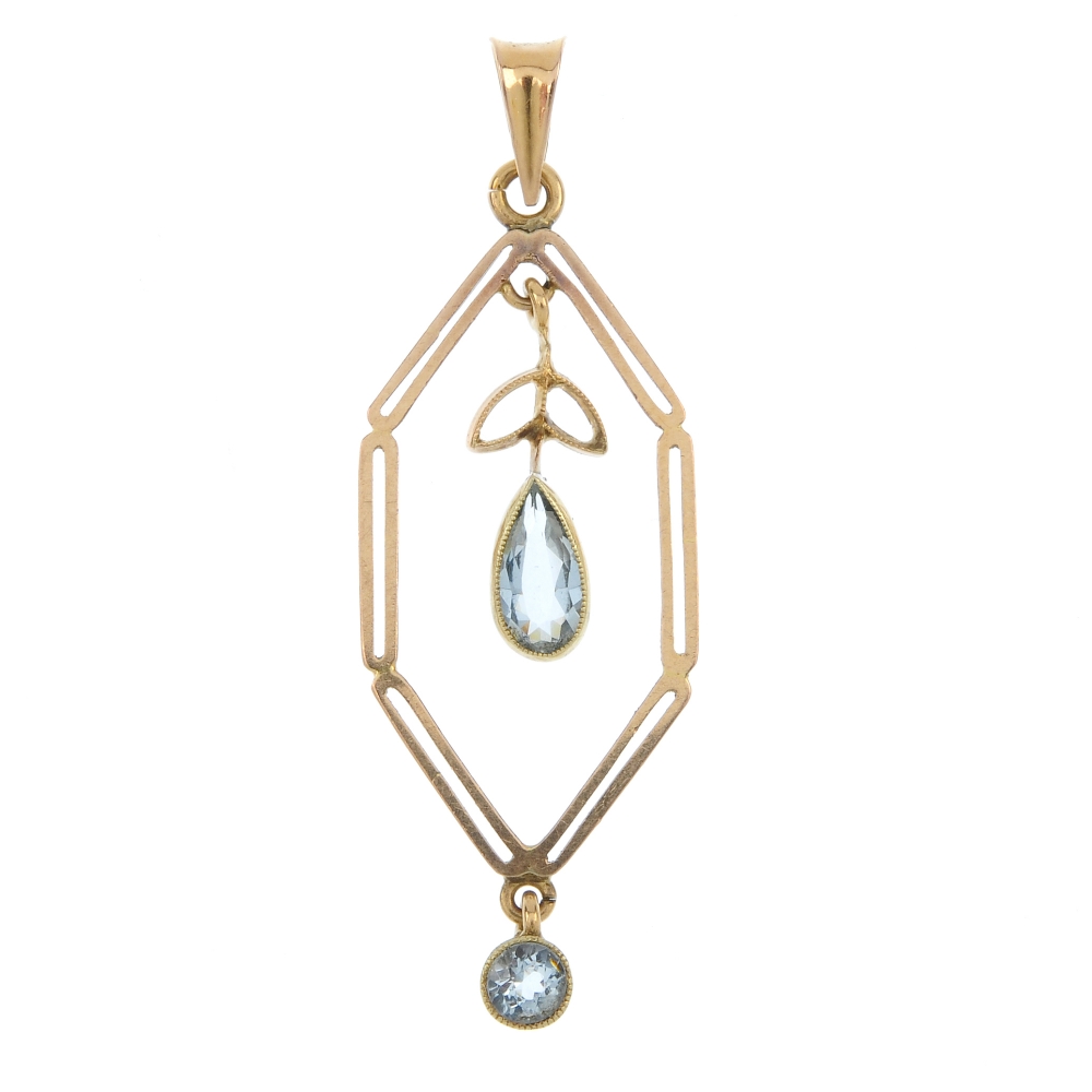 An early 20th century gold aquamarine pendant. Designed as a pear-shape aquamarine foliate drop,