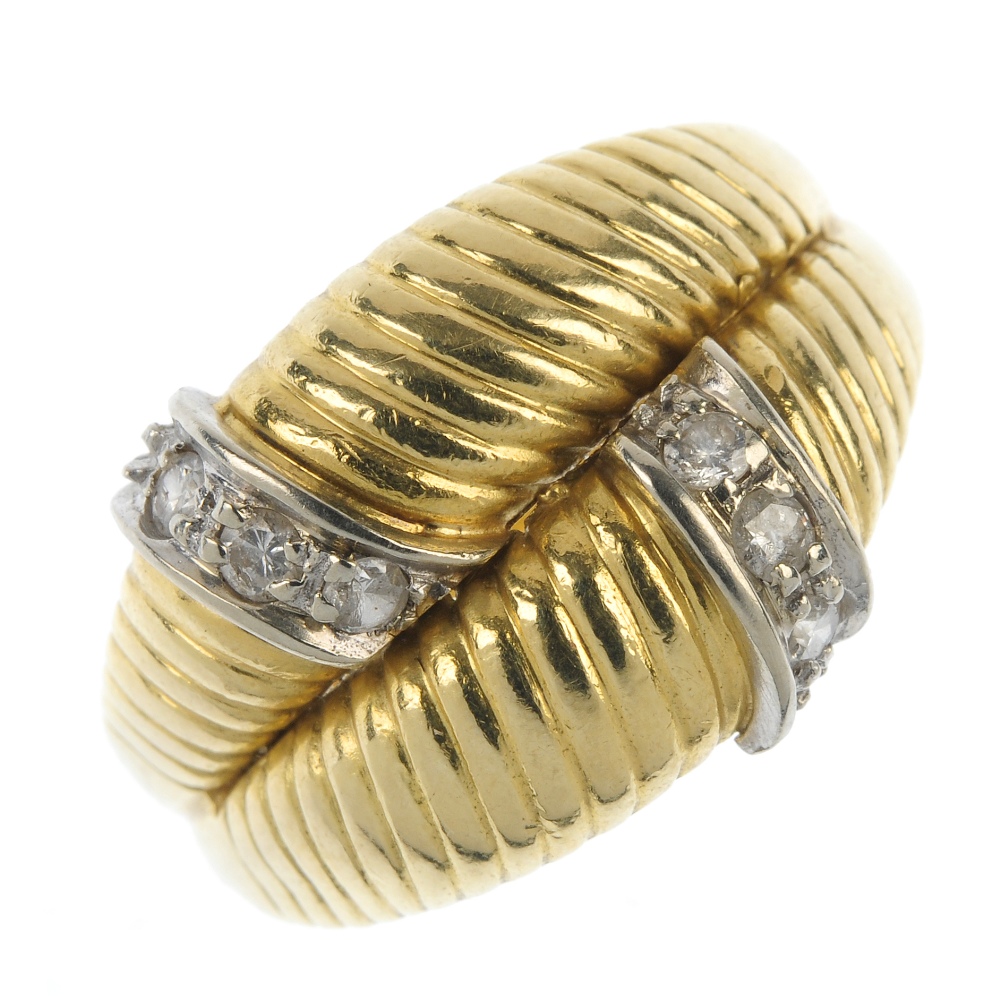 A diamond dress ring. Comprising two grooved panels, with brilliant-cut diamond line accents, to