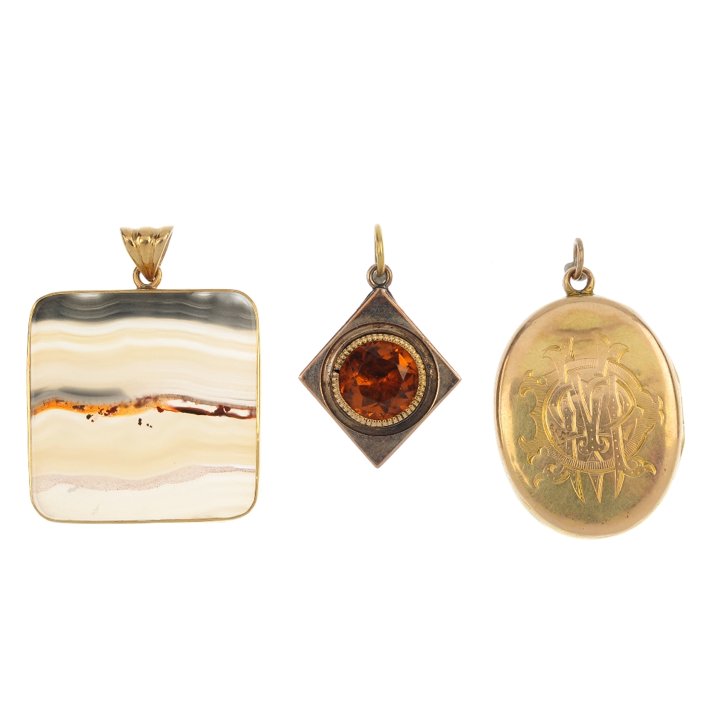 A selection of three pendants. To include a late Victorian gold monogrammed memorial locket, a 9ct