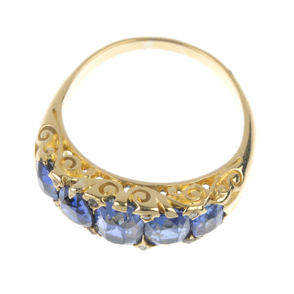 A sapphire and diamond five-stone ring. The graduated rectangular and oval-shape sapphires, with - Image 2 of 4