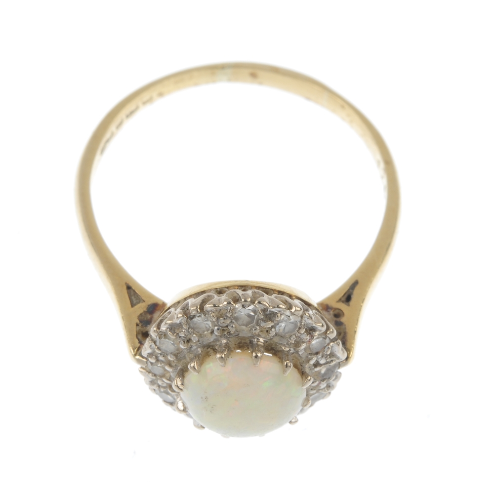 An 18ct gold opal and diamond cluster ring. The circular opal cabochon, within a single-cut diamond - Image 2 of 4