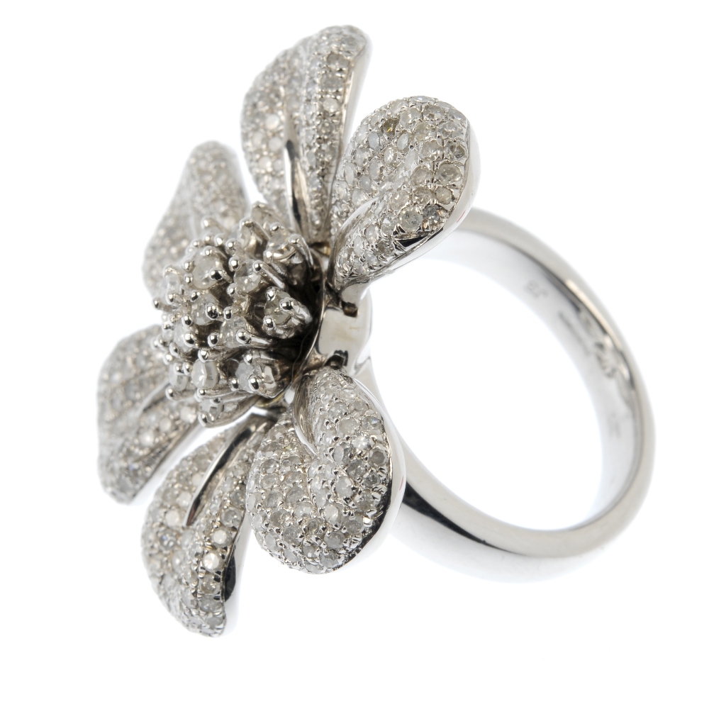 A silver diamond floral ring. The brilliant-cut diamond stepped cluster, with six articulated pave- - Image 3 of 4