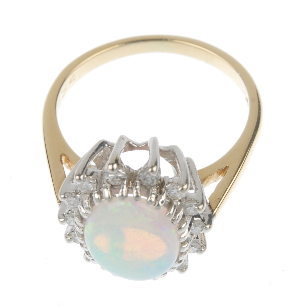 An opal and diamond cluster ring. The oval opal cabochon, within a single-cut diamond accent - Image 2 of 4