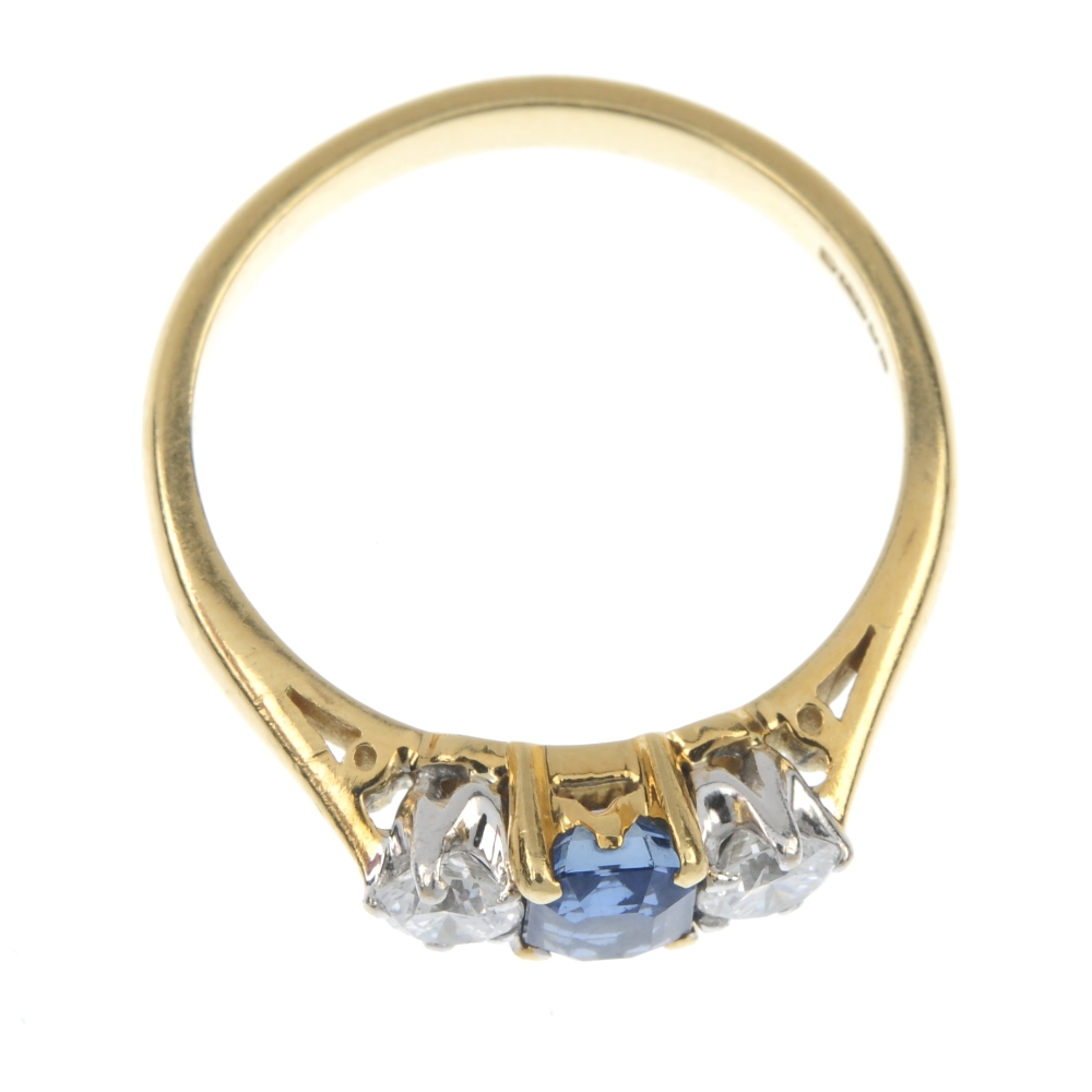 An 18ct gold sapphire and diamond three-stone ring. The rectangular-shape sapphire, with brilliant- - Image 2 of 4