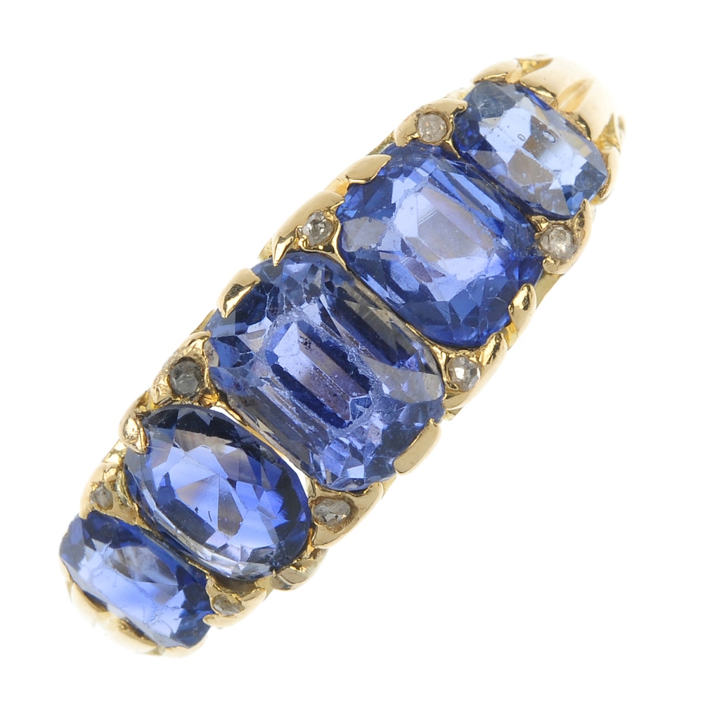 A sapphire and diamond five-stone ring. The graduated rectangular and oval-shape sapphires, with