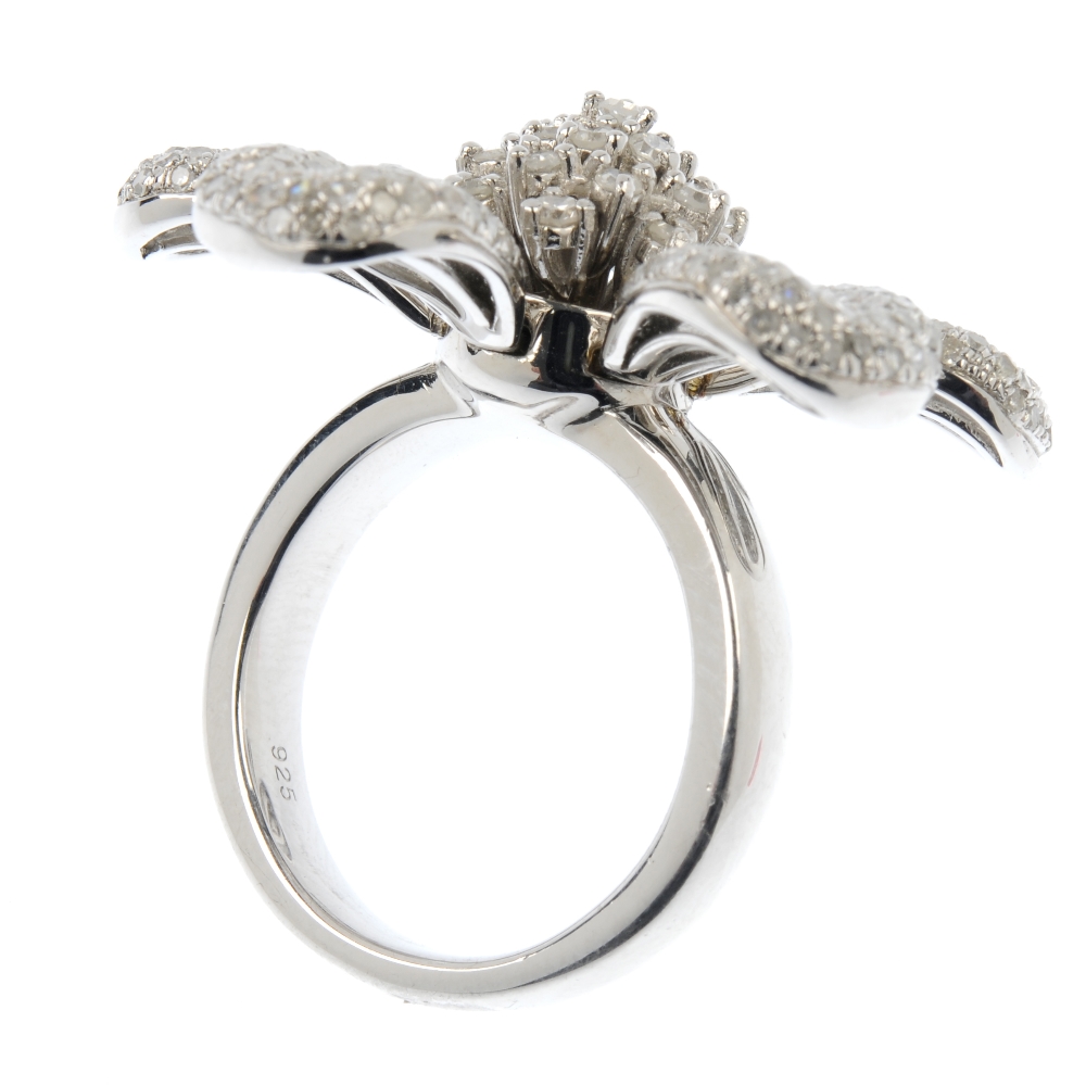 A silver diamond floral ring. The brilliant-cut diamond stepped cluster, with six articulated pave- - Image 4 of 4