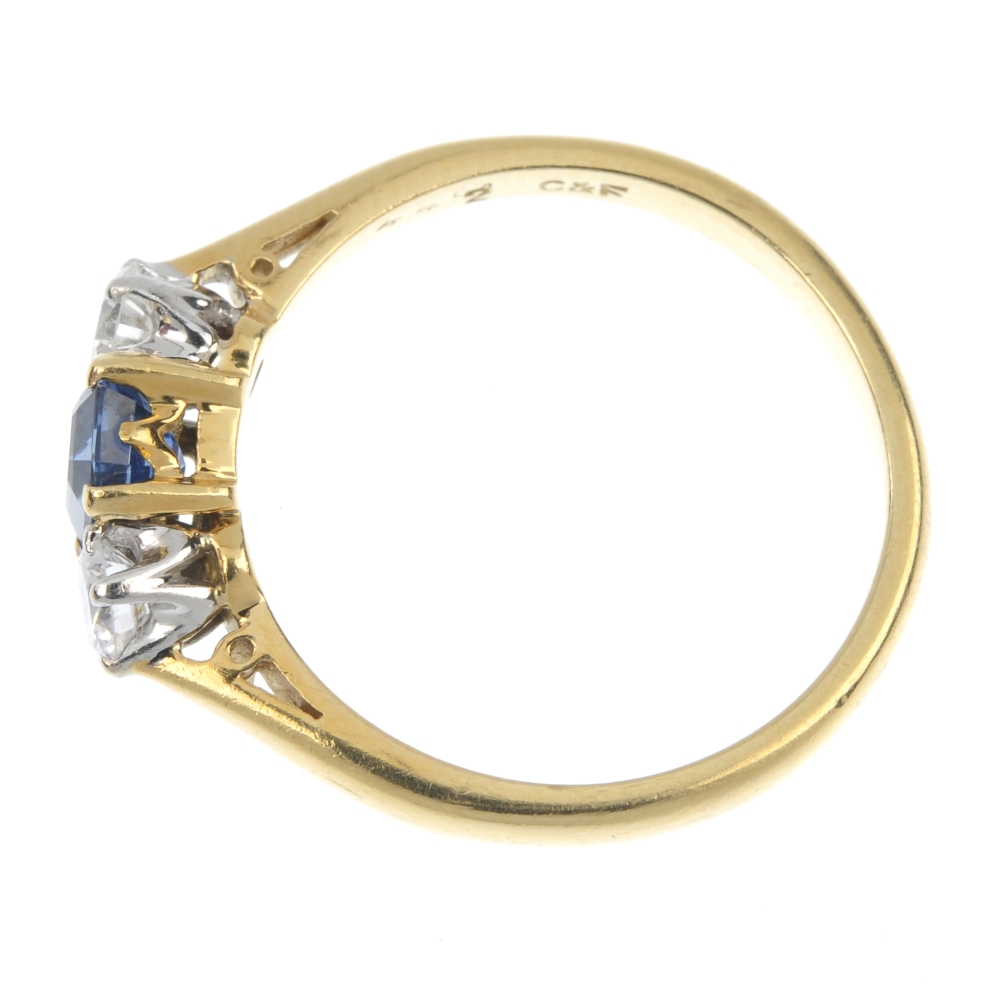 An 18ct gold sapphire and diamond three-stone ring. The rectangular-shape sapphire, with brilliant- - Image 3 of 4