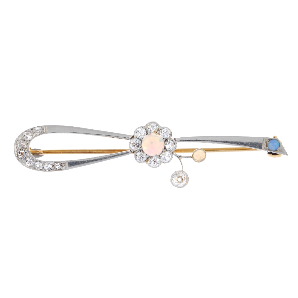 An early 20th century platinum and 18ct gold opal and diamond brooch. The circular opal cabochon