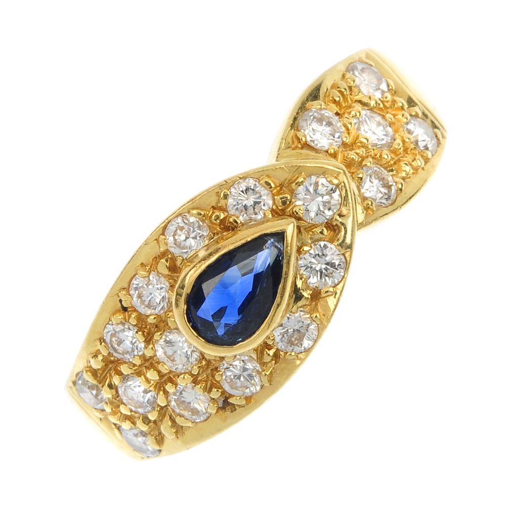 An 18ct gold sapphire and diamond dress ring. The pear-shape sapphire, to the brilliant-cut diamond