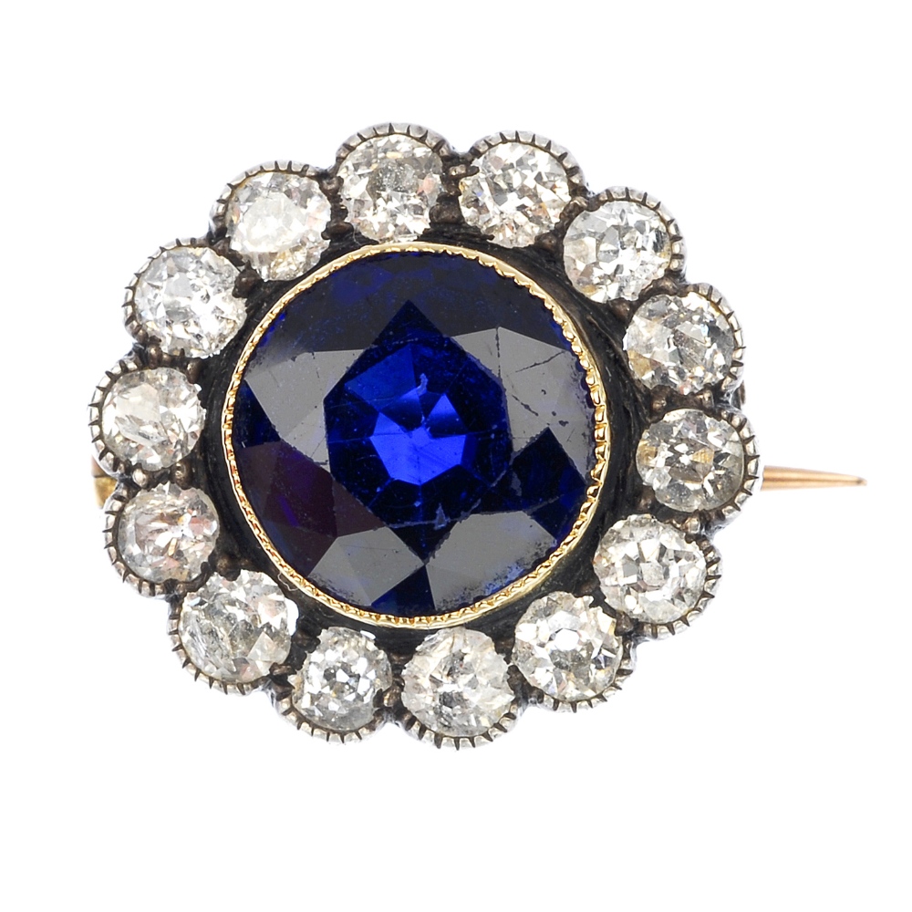 An early 20th century silver and 9ct gold sapphire and diamond cluster brooch. The circular-shape