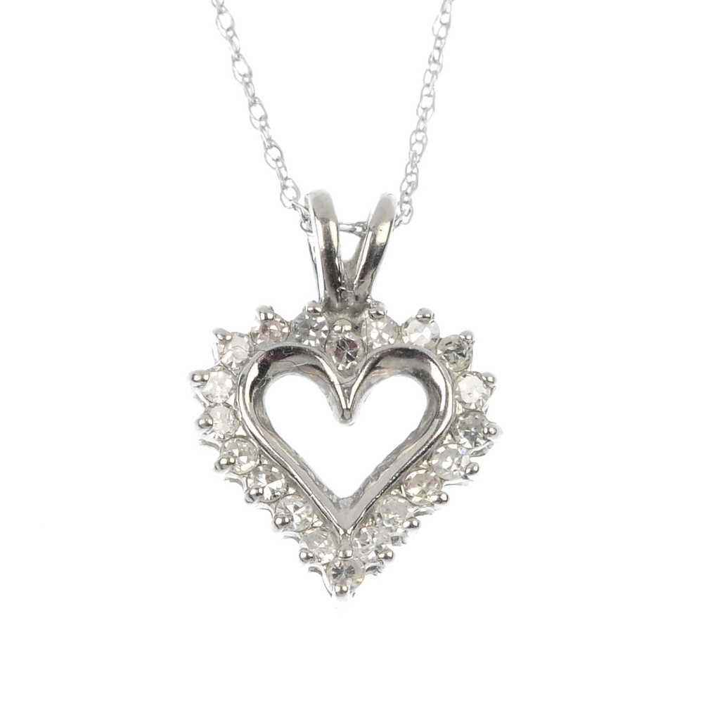 A diamond heart pendant. The single-cut diamond heart-shape panel, with scrolling line accent, to