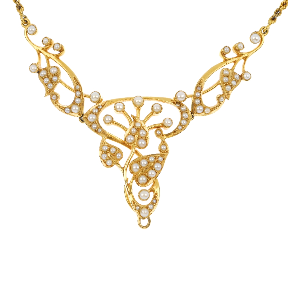 An early 20th century 15ct gold split pearl necklace. Of openwork design, the split pearl stylised