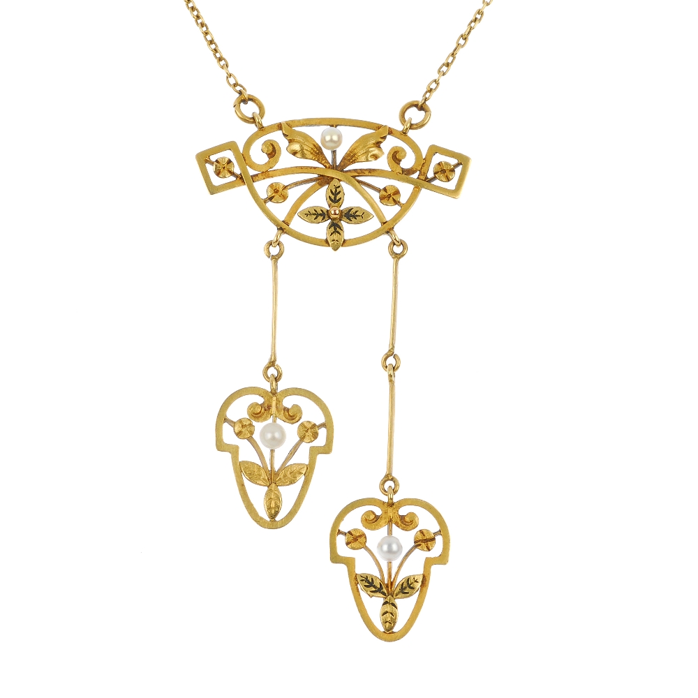 An early 20th century 18ct gold negligee pendant. Of openwork design, the slightly graduated