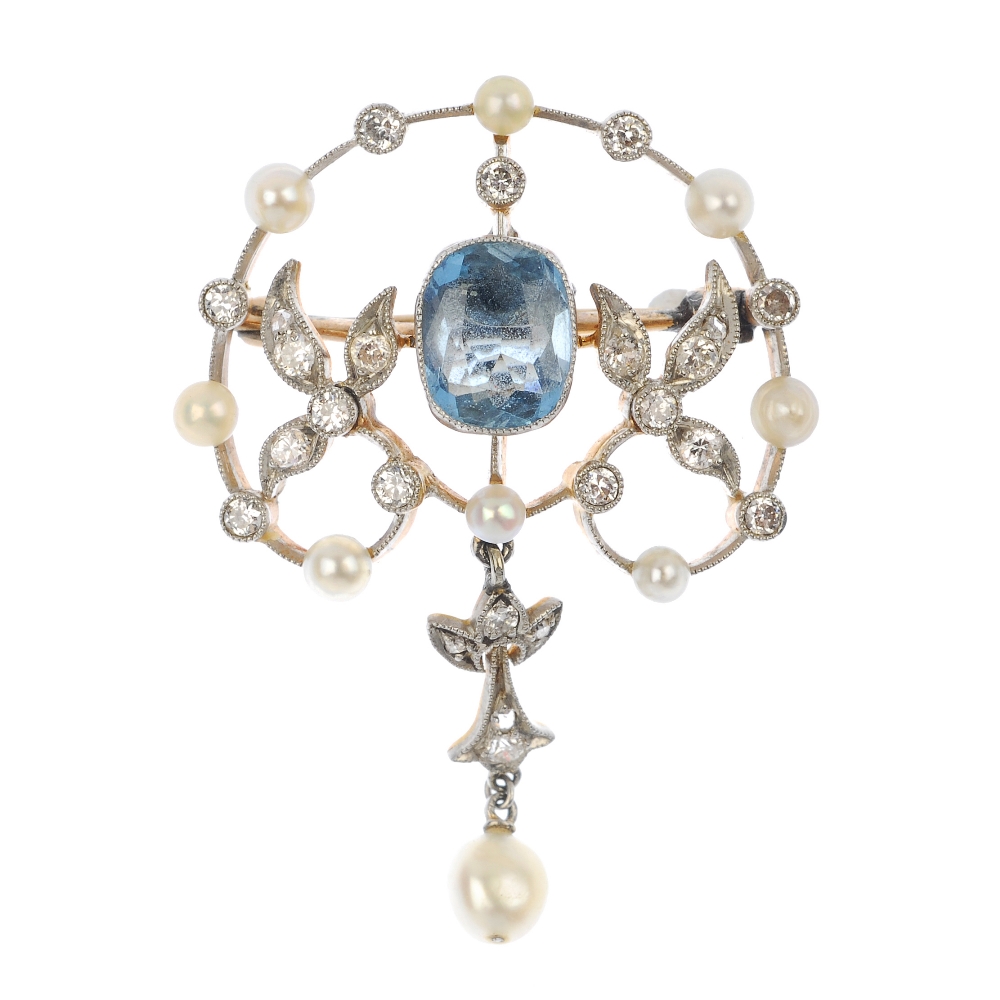 An early 20th century silver and 9ct gold diamond and gem-set brooch. Of openwork design, the