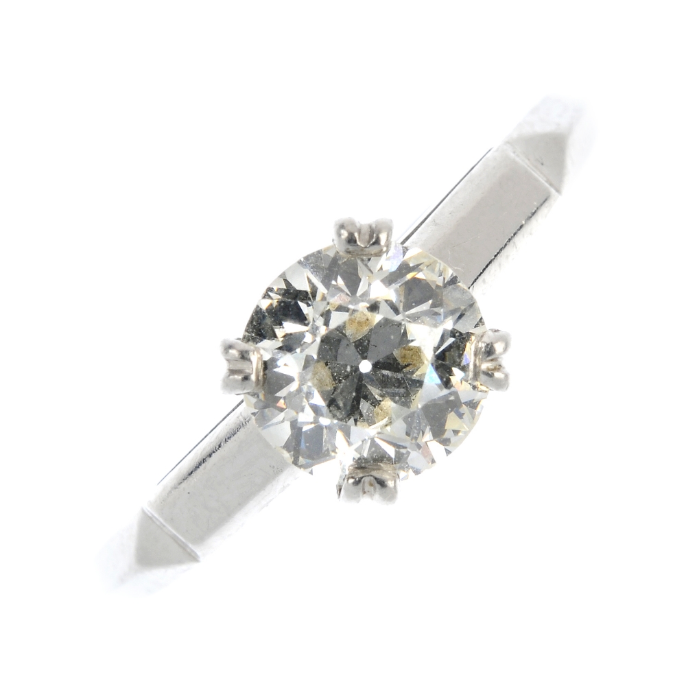 A diamond single-stone ring. The brilliant-cut diamond, to the polished panel shoulders and