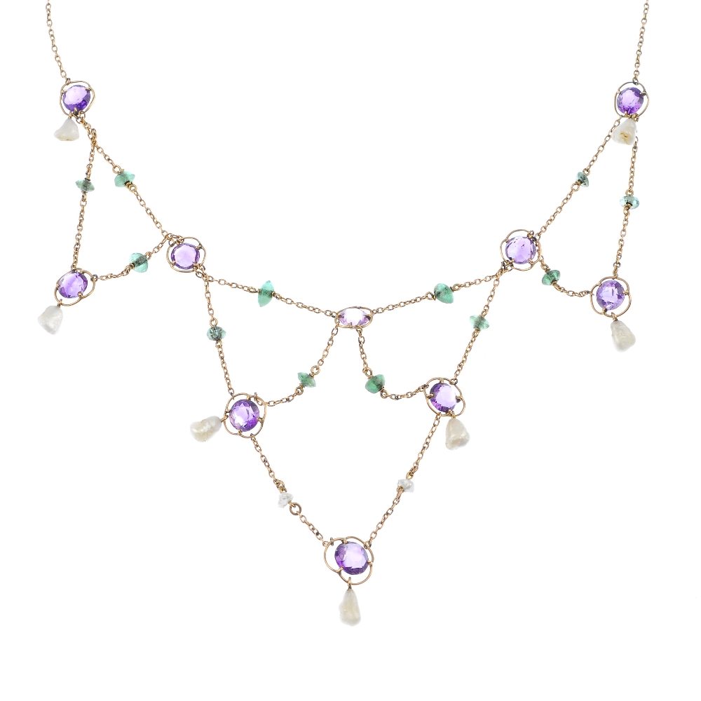 An early 20th century 15ct gold amethyst, emerald and baroque pearl garland necklace. Designed as