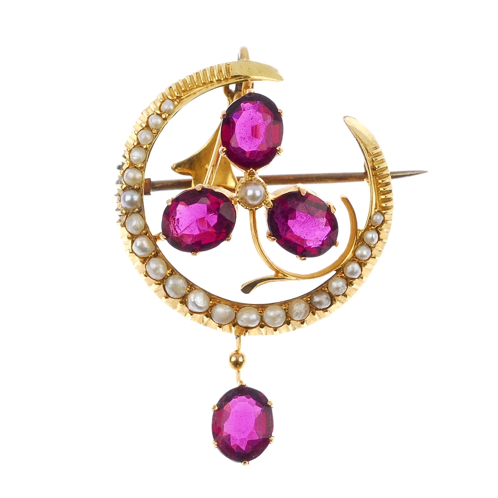 An early 20th century 9ct gold split pearl and garnet pendant. The seed pearl crescent with oval-